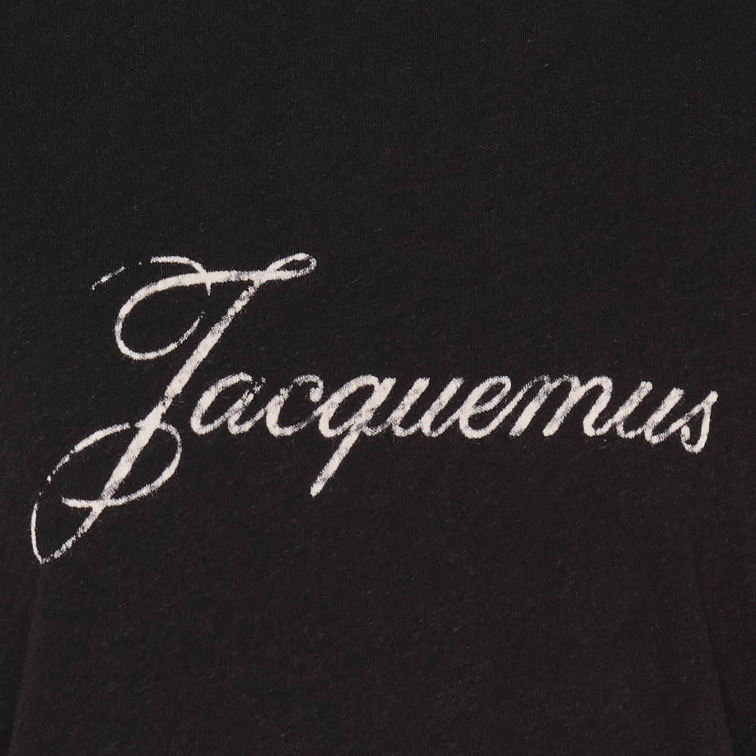 Jacquemus black oversized short-sleeve t-shirt with embroidered cursive logo across the chest and ribbed crew neckline, displayed on a white background - view 4