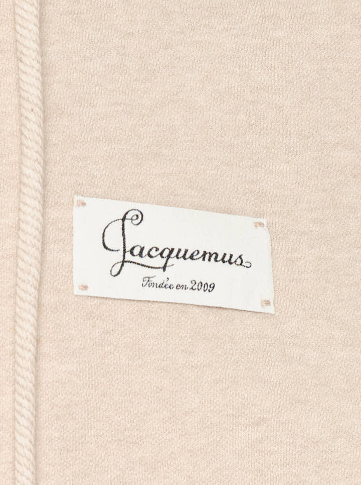Jacquemus Montaigne oversized zip-up hoodie in beige with drawstring hood, ribbed cuffs and woven chest label - view 3