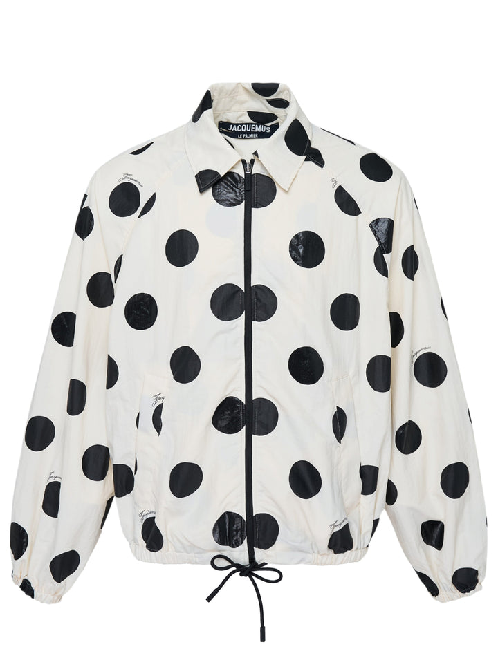 Jacquemus Le Palmier cream windbreaker jacket with large black polka dots, zip front, collar and drawstring hem