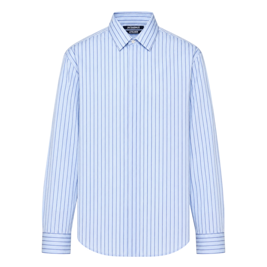 Jacquemus La Chemise Simon long sleeve shirt in light blue with navy vertical pinstripes, featuring a classic point collar and double-button barrel cuffs