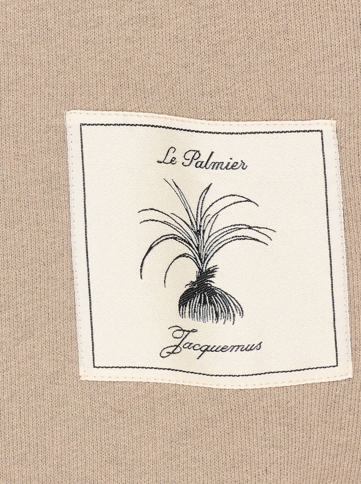 Jacquemus Torneo sweatshirt in taupe with ribbed mock neck and a Le Palmier palm illustration label at the hem - view 3