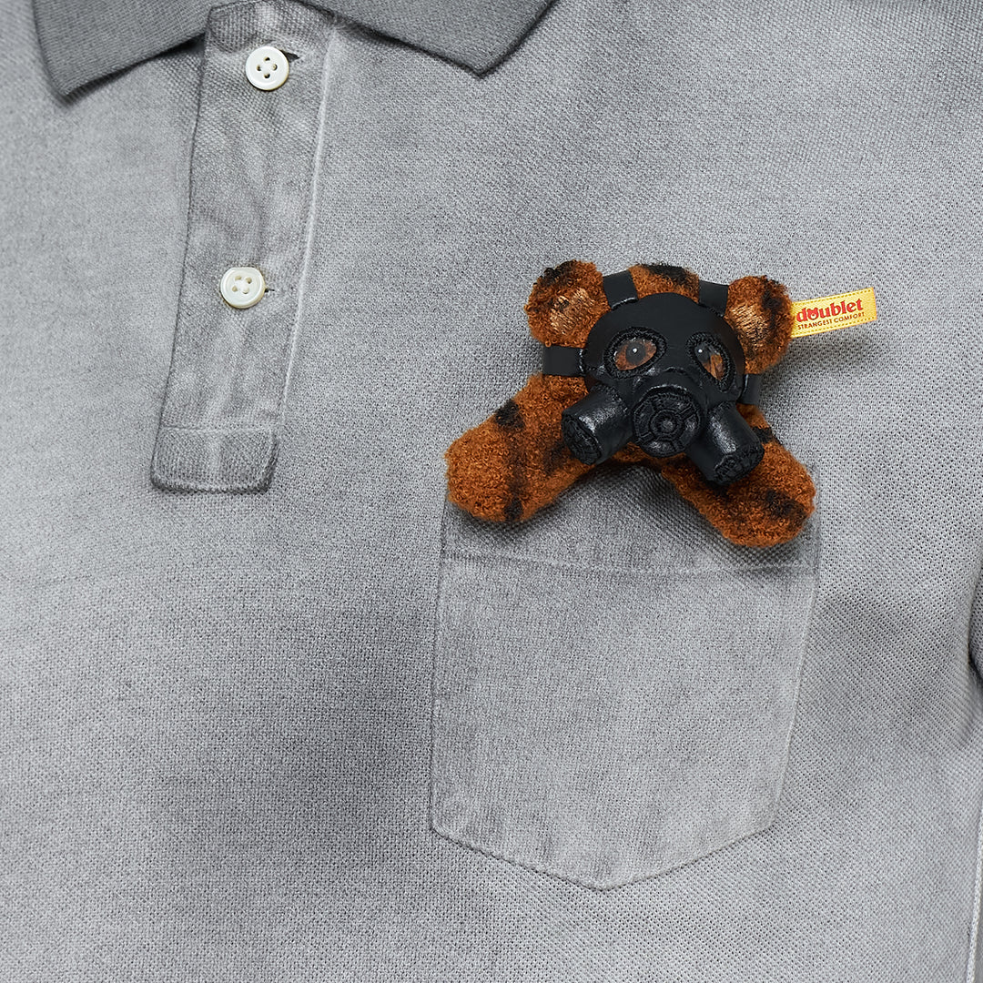 doublet Gas Mask Bear Polo Shirt in dark navy piqué with contrast chambray collar and a miniature Steiff tiger-print teddy bear wearing a gas mask in the chest pocket