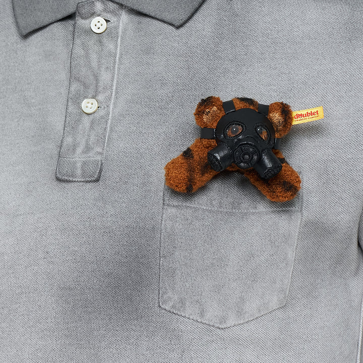 doublet Gas Mask Bear Polo Shirt in dark navy piqué with contrast chambray collar and a miniature Steiff tiger-print teddy bear wearing a gas mask in the chest pocket