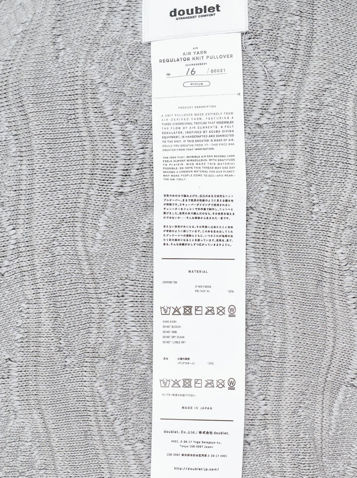 doublet Air Yarn Regulator Knit Pullover in grey, featuring distressed cable-knit texture across the body and sleeves with an attached scuba regulator hardware detail on the sleeve, crew neckline, shot flat on a white background - view 4