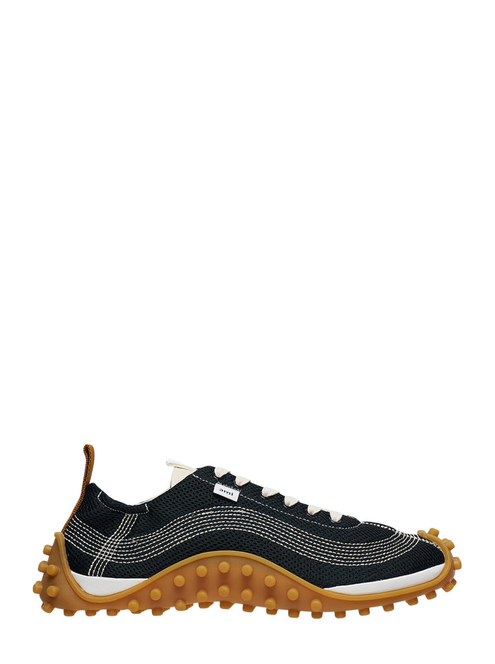 Ami Mirage Sneakers in black mesh with white contrast topstitching, cream laces, and a chunky tan gum rubber outsole with dome studs, side profile view