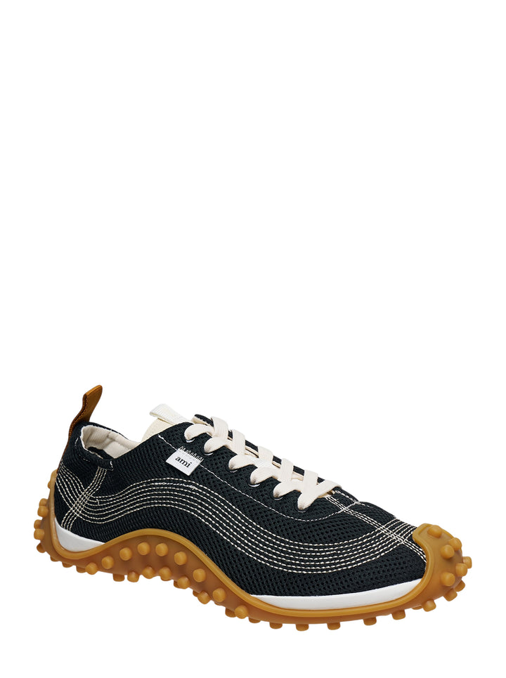 Ami Mirage Sneakers in black mesh with white contrast topstitching, cream laces, and a chunky tan gum rubber outsole with dome studs, side profile view - view 2