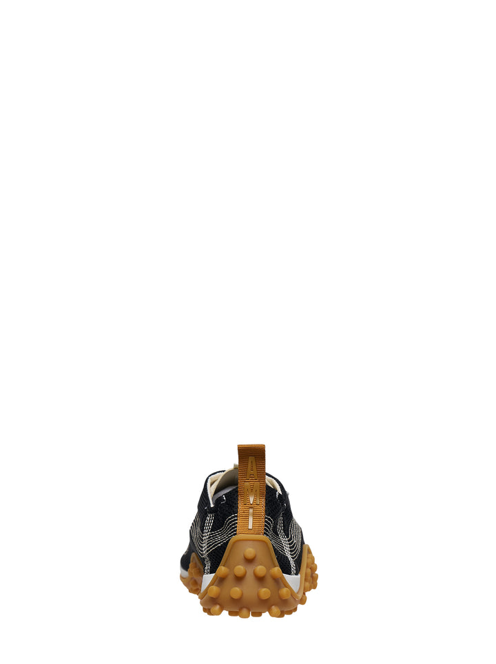 Ami Mirage Sneakers in black mesh with white contrast topstitching, cream laces, and a chunky tan gum rubber outsole with dome studs, side profile view - view 3