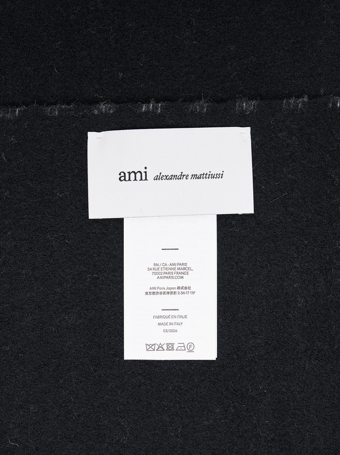 AMI Ami de Coeur black and white gingham check scarf with fringed ends, laid flat against a white background - view 3