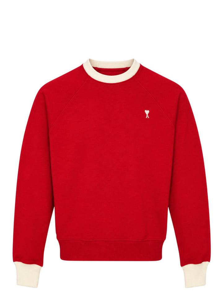 AMI Paris Bicolor Crewneck Sweatshirt in red with cream contrast ribbed collar and cuffs, featuring an embroidered Ami de Cœur logo on the chest