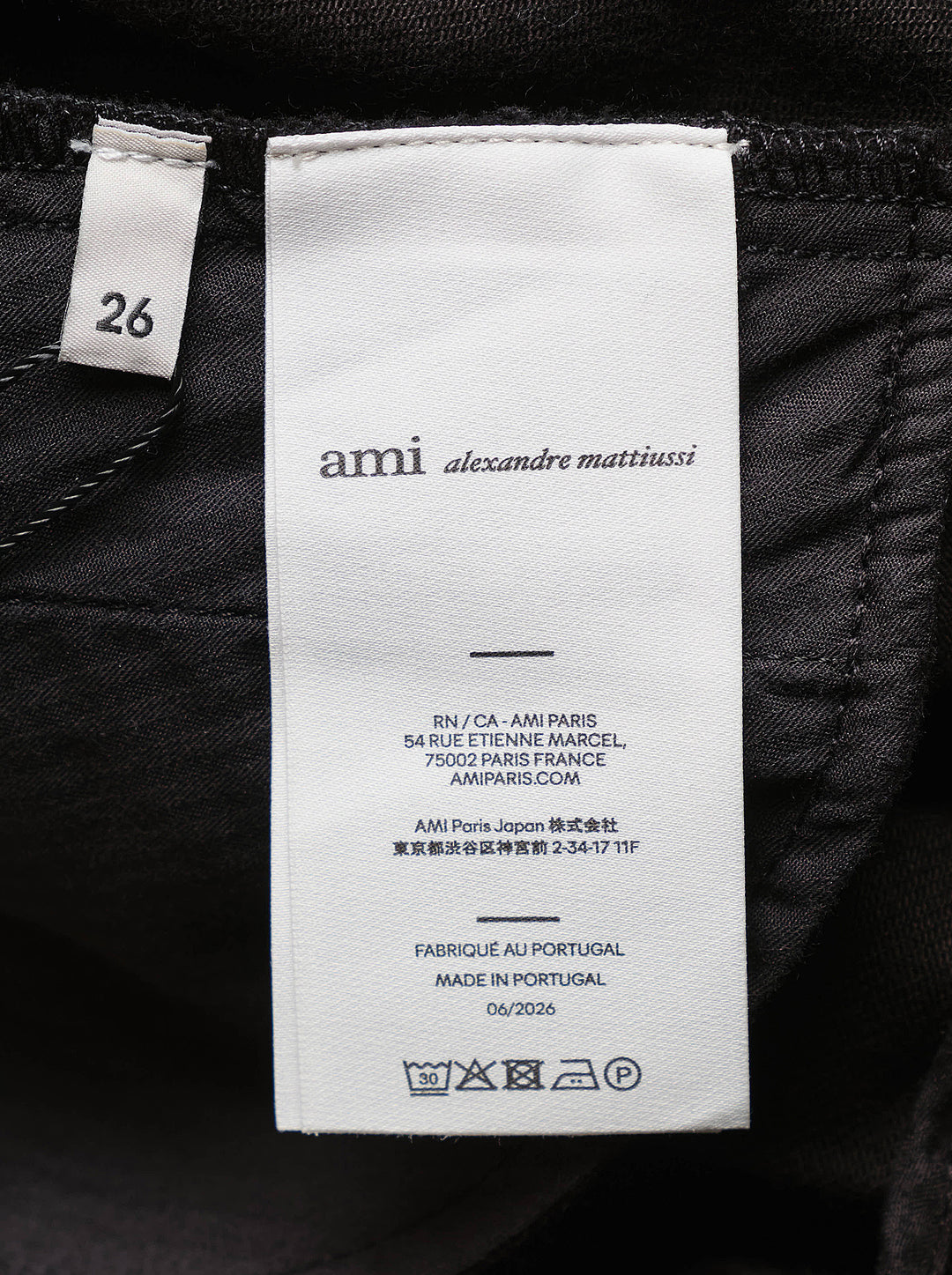 AMI black midi godet skirt with flared paneled silhouette and asymmetric hem, shown from the front - view 3