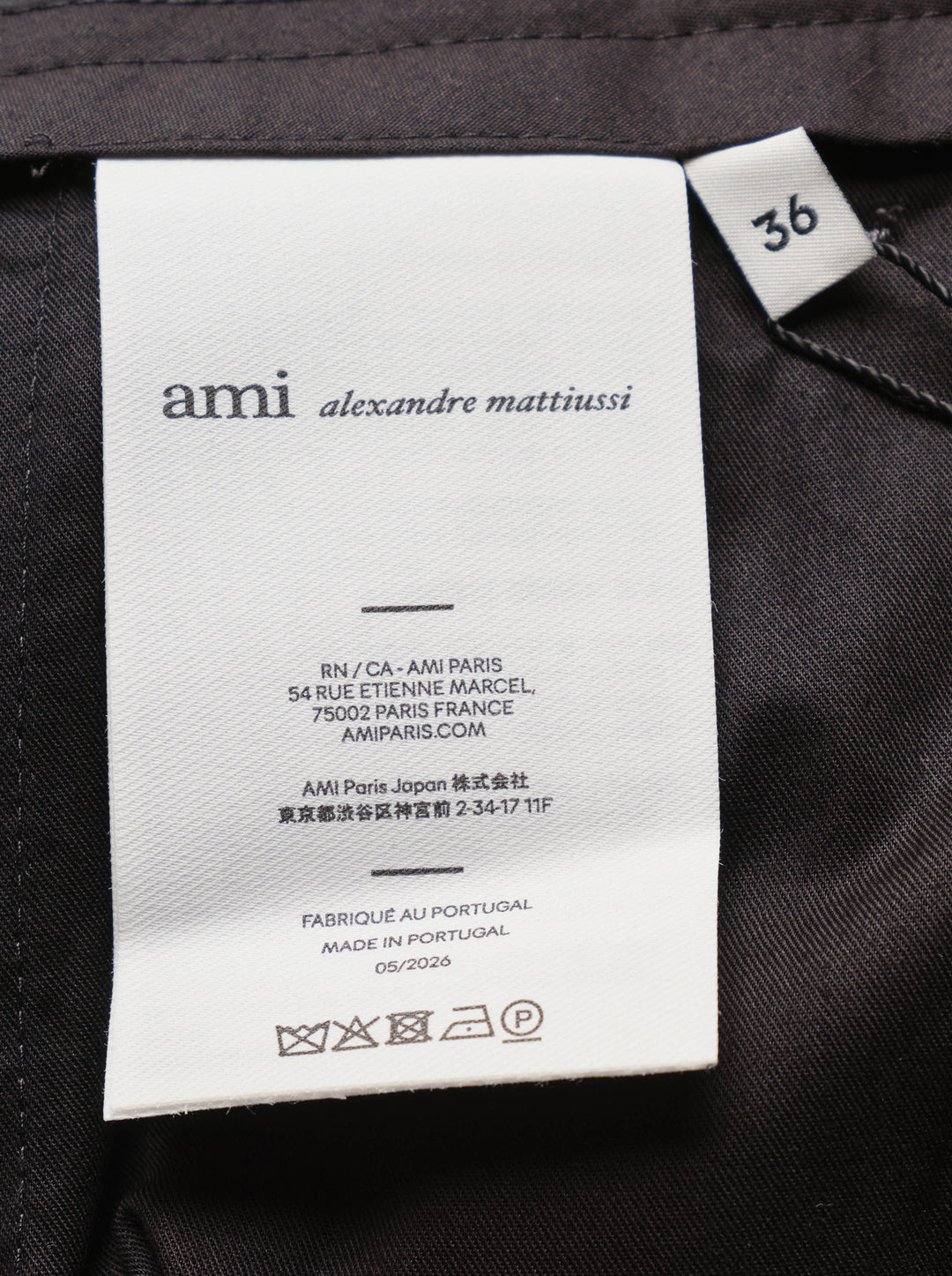 AMI Pleated Carrot Shorts in medium grey, featuring a high-rise waistband, double forward pleats, wide-leg carrot silhouette, and cuffed hem, displayed flat on a white background. - view 3