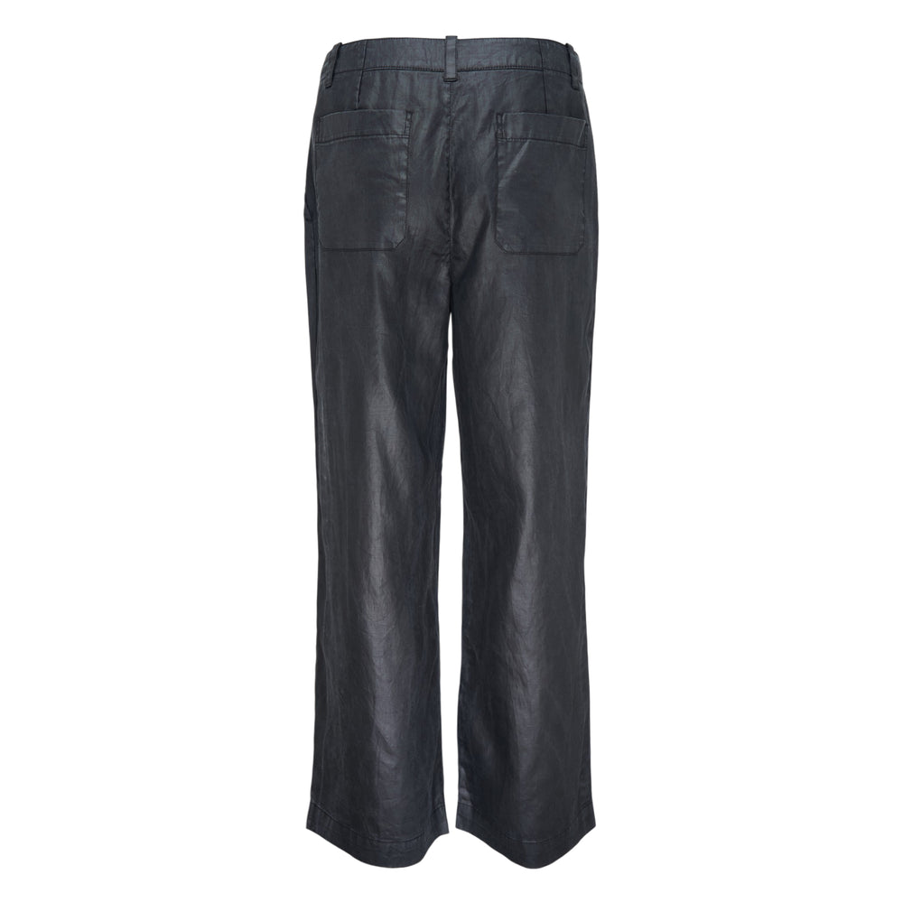 Our Legacy Still Chino Pants in dark navy with a wide-leg silhouette, coated finish, front crease, and mid-rise waistband, displayed on a flat white background