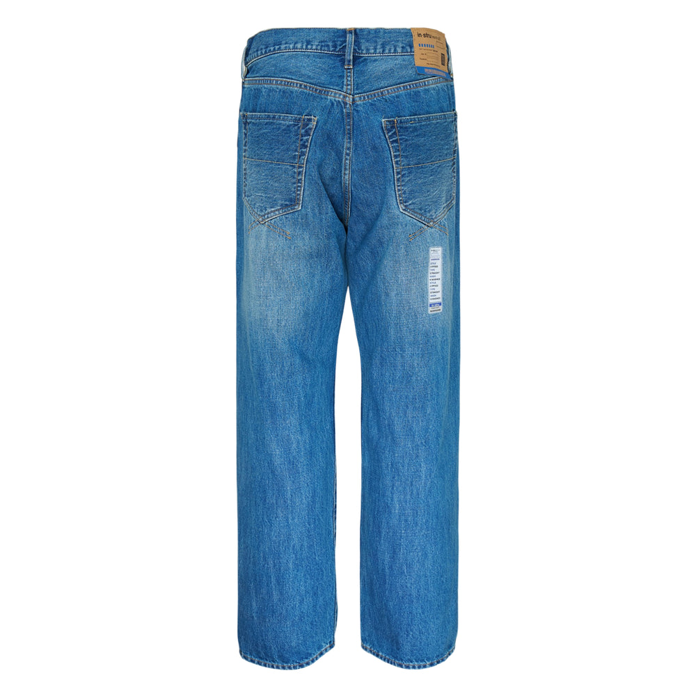 Mihara Yasuhiro Hard Washed Selvedge Straight Jeans in medium blue with vintage fading and a branded care-label patch on the leg, flat lay front view - view 2