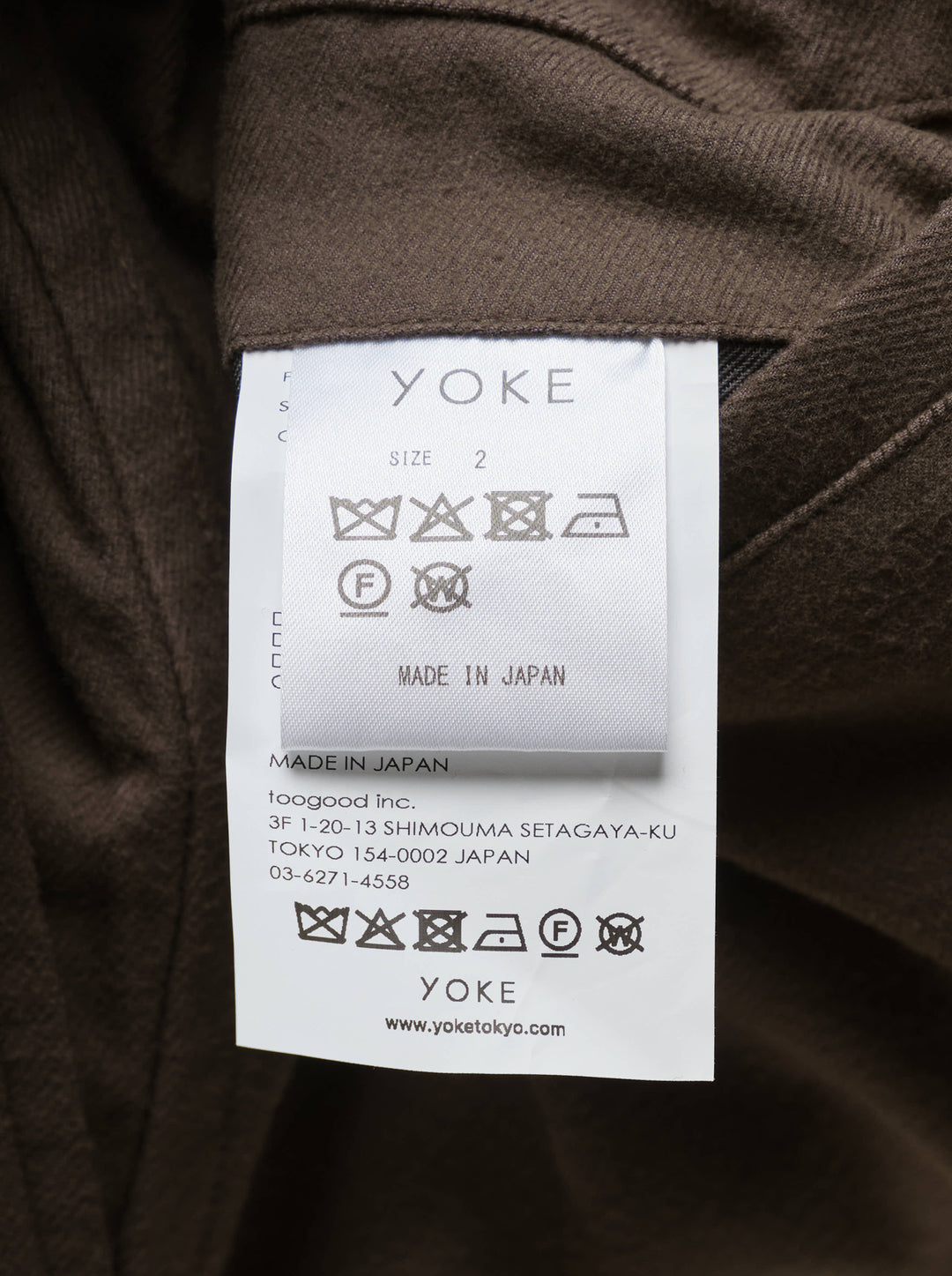 Brown wide-leg pleated trousers with an elasticated waistband, button closure and cropped hem, shown from the front - view 3