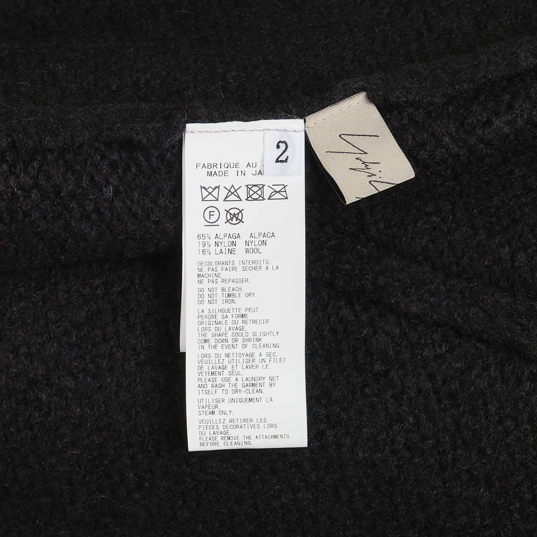 Yohji Yamamoto String Detail Cardigan in black — oversized open-front knit with tie-string hem detail and ribbed cuffs, displayed on a mannequin - view 3