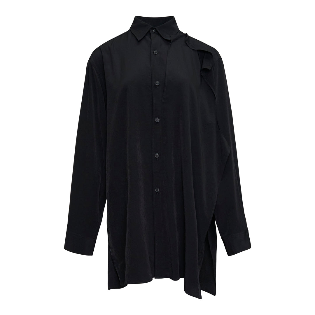 Y's black double cloth button-front blouse with asymmetric draped ruffle at the shoulder, oversized silhouette, long sleeves, and side hem slits