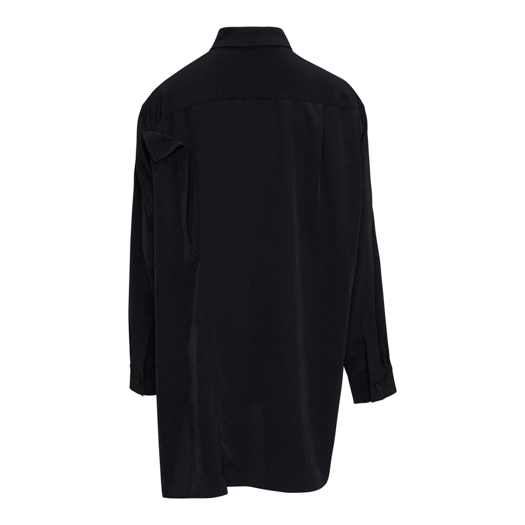 Y's black double cloth button-front blouse with asymmetric draped ruffle at the shoulder, oversized silhouette, long sleeves, and side hem slits