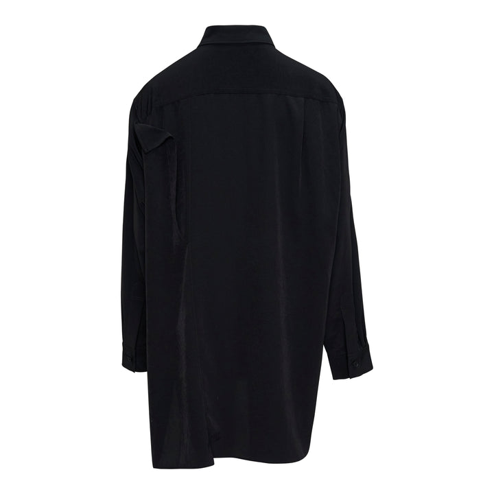 Y's black double cloth button-front blouse with asymmetric draped ruffle at the shoulder, oversized silhouette, long sleeves, and side hem slits