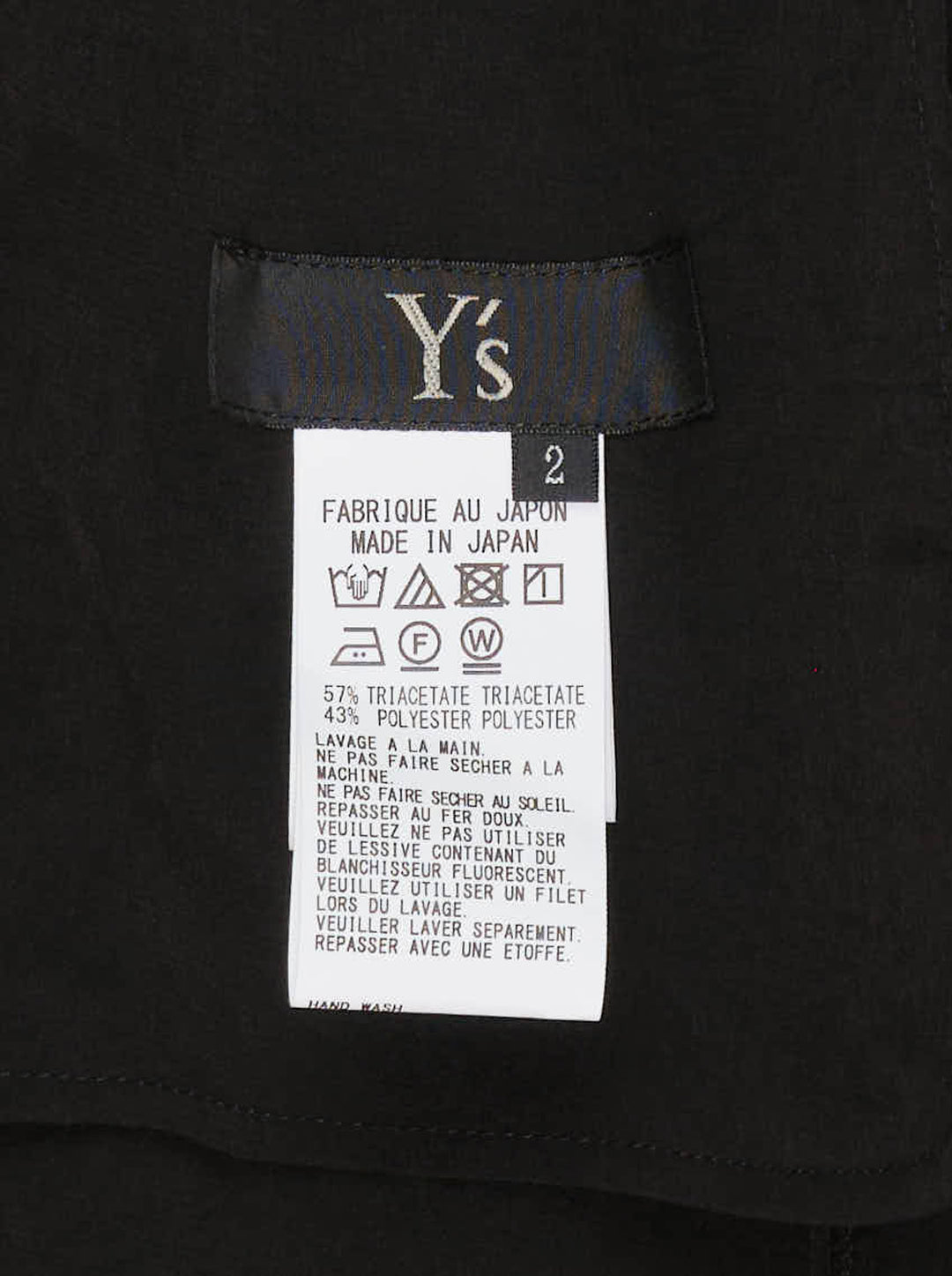 Y's black halter apron jumpsuit with an asymmetric draped bib and wide-leg silhouette, shown from the front - view 3