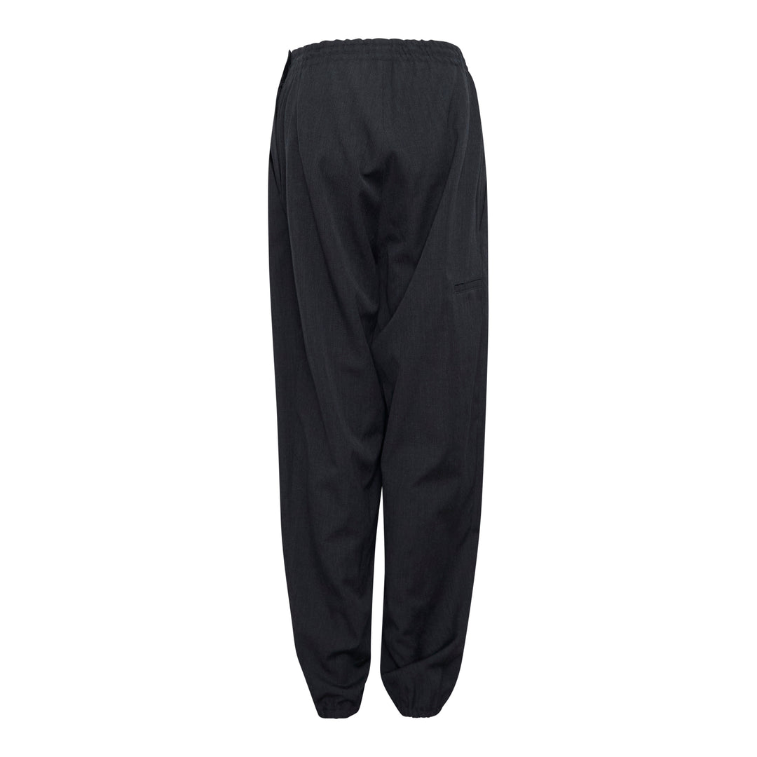 Y's black relaxed-fit drawstring joggers with drop-crotch silhouette, elasticated high-rise waistband with tonal tie, and gathered ankle cuffs, displayed flat on a white background