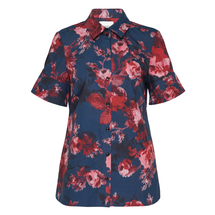 Erdem navy cotton poplin short sleeve blouse with large-scale crimson and blush rose floral print, flutter ruffle cuffs, and dark button-through front placket