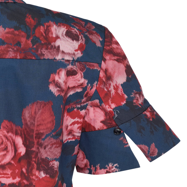 Erdem navy cotton poplin short sleeve blouse with large-scale crimson and blush rose floral print, flutter ruffle cuffs, and dark button-through front placket