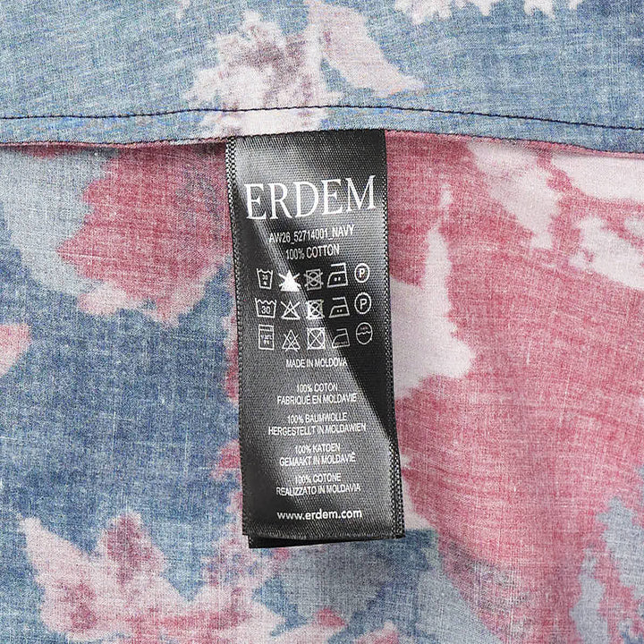 Erdem navy cotton poplin short sleeve blouse with large-scale crimson and blush rose floral print, flutter ruffle cuffs, and dark button-through front placket