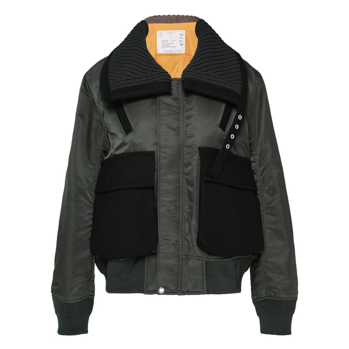 sacai Nylon Twill x Wool Melton Blouson in olive green, featuring an oversized ribbed knit collar, contrast black wool patch pockets, eyelet hardware detail, and orange satin lining at the collar reverse