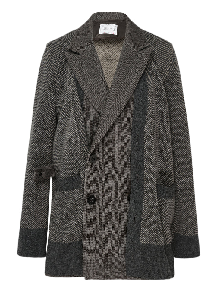 sacai double-faced herringbone blazer coat in mixed grey tones, featuring patchwork herringbone panels, double-breasted button fastening, wide notch lapels, and contrast charcoal trim at the hem and cuffs