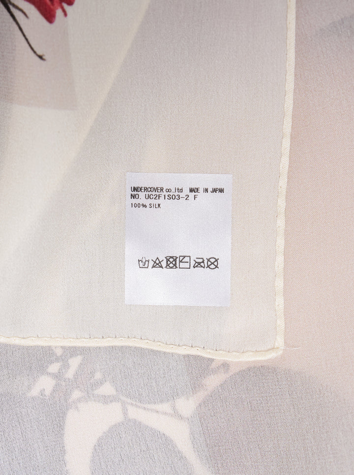 Undercover square scarf printed with five clusters of red roses, buds, and green leaves on an ivory ground with a pale border - view 2