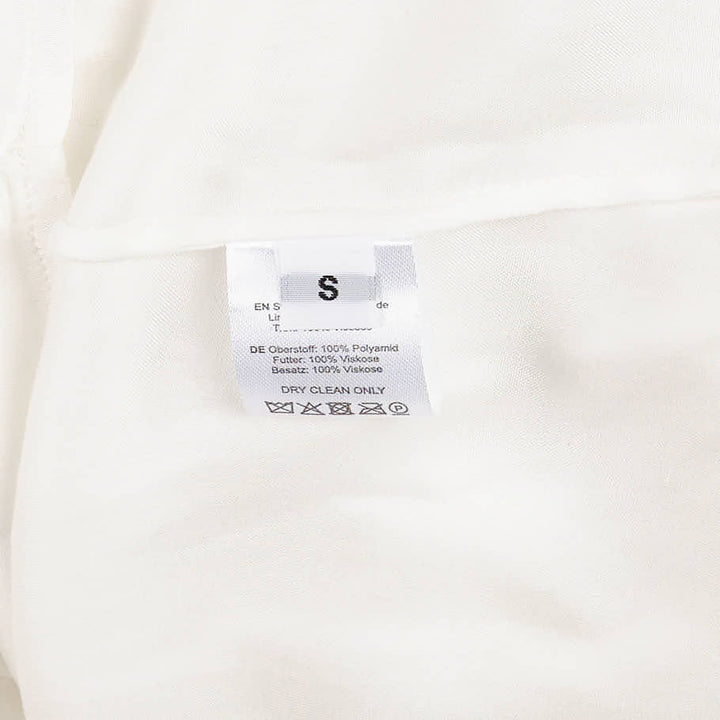 Hisu Park Glass Mini Skirt in white, featuring cascading sheer organza ruffles in undulating rows against a light grey background - view 7