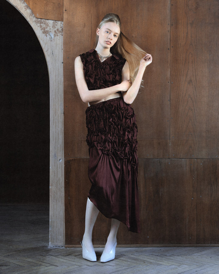 Hisu Park Jenny Skirt in deep burgundy satin with ruched floral-style gathered detailing on the upper skirt and an asymmetric draped midi hem - view 6