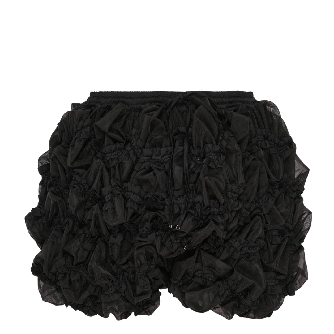 Hisu Park Glass Shorts in black — heavily ruffled organza-effect mini shorts with elasticated waistband, drawstring tie, and smocked detailing throughout