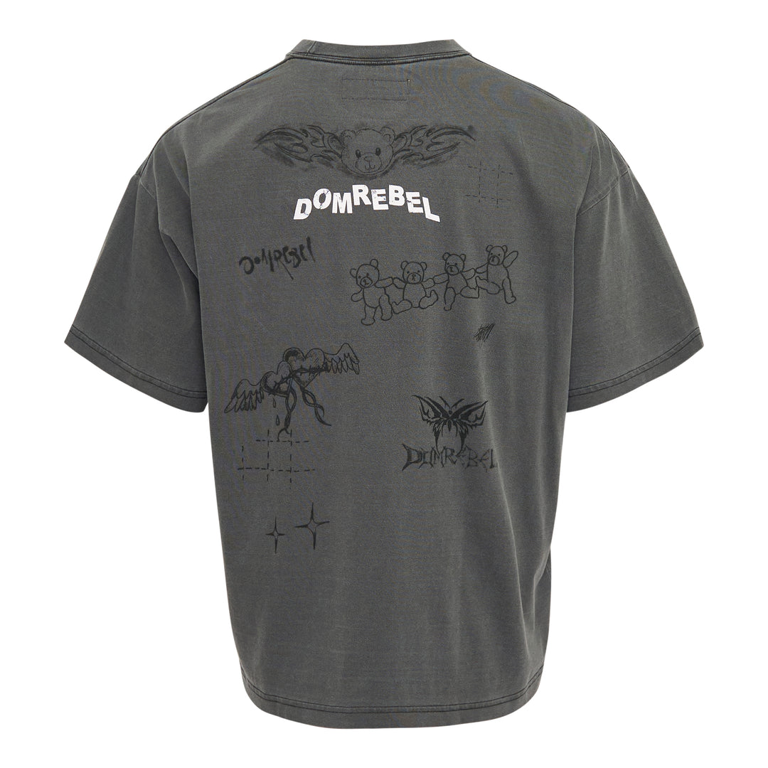 Domrebel washed grey oversized graphic tee featuring a large teddy bear in briefs, hand-scrawled typography, star and barbed wire motifs, and Domrebel Studios branding