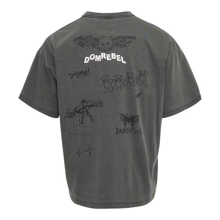 Domrebel washed grey oversized graphic tee featuring a large teddy bear in briefs, hand-scrawled typography, star and barbed wire motifs, and Domrebel Studios branding