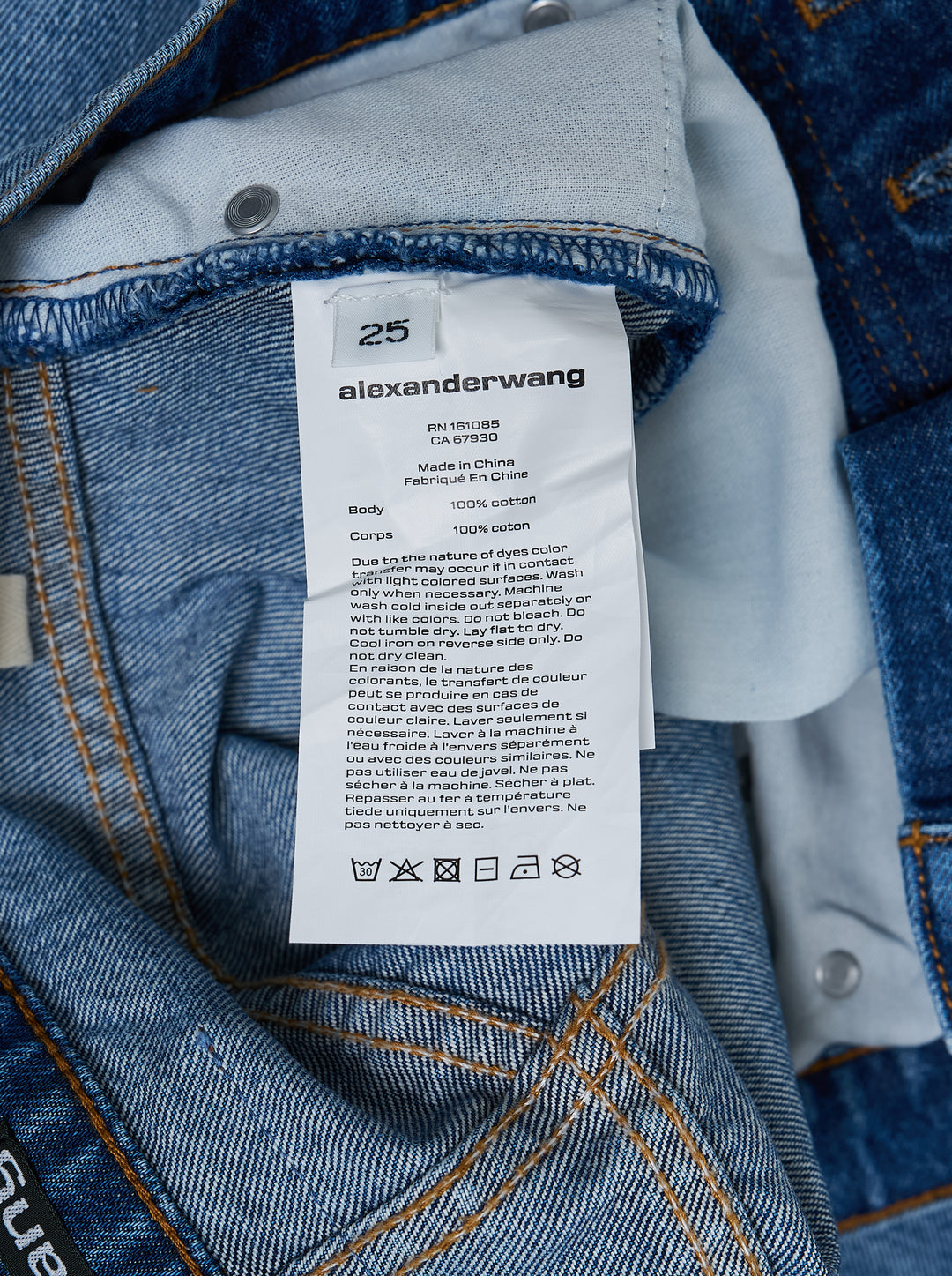 Alexander Wang Float Jeans in washed mid-blue denim with a high rise and curved twisted-seam leg, shown from the front - view 3