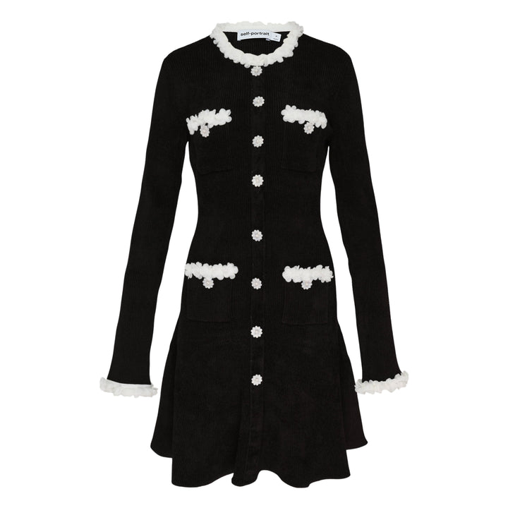 Self-Portrait black chenille ribbed knit mini dress with white floral trim at neckline, cuffs, and patch pockets, daisy button front fastening, fit-and-flare silhouette