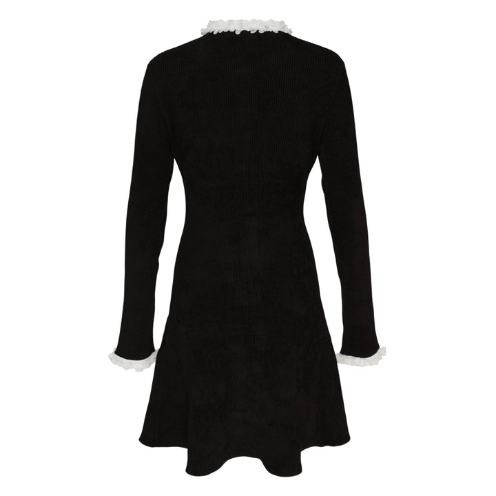 Self-Portrait black chenille ribbed knit mini dress with white floral trim at neckline, cuffs, and patch pockets, daisy button front fastening, fit-and-flare silhouette