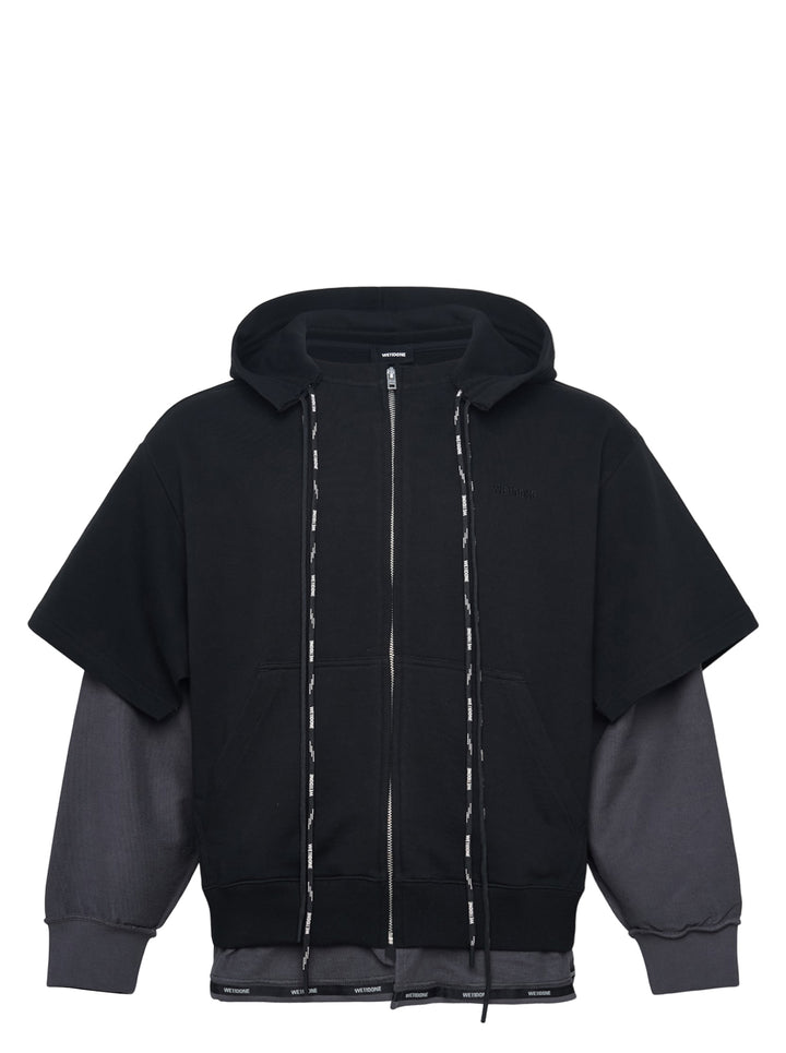 We11done Black Layered Double String Hoodie with contrast charcoal grey extended sleeves, full-length zip closure, logo drawstrings, and branded ribbed hem — front view