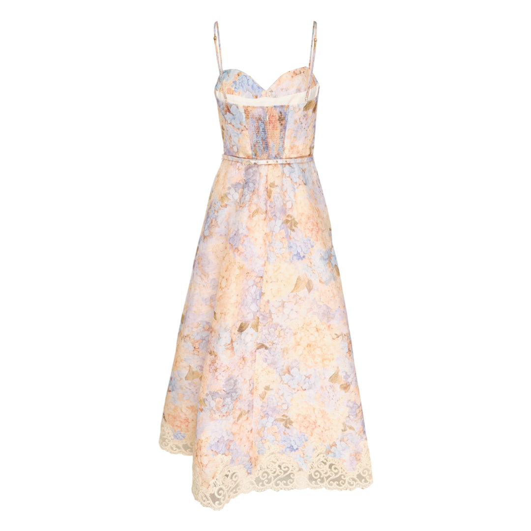 Zimmermann Valiant Tucked Midi Dress in a pastel hydrangea floral print, featuring a structured sweetheart bustier bodice, adjustable spaghetti straps, a self-belt at the waist, and an A-line skirt with ivory lace scrollwork trim at the hem
