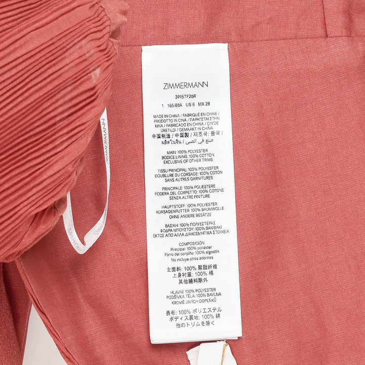 Zimmermann Pleated Bodice Wrap Top in terracotta, featuring a crossover pleated front, voluminous puff sleeves in crinkled woven fabric, and ruffled elasticated cuffs