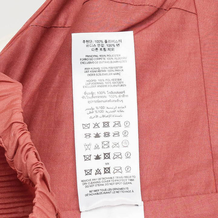 Zimmermann Pleated Bodice Wrap Top in terracotta, featuring a crossover pleated front, voluminous puff sleeves in crinkled woven fabric, and ruffled elasticated cuffs