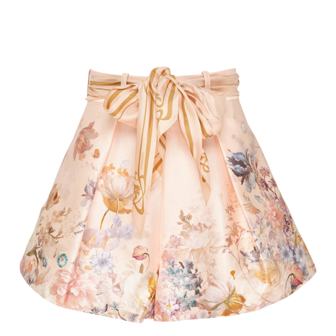 Zimmermann Valiant Tuck Shorts in blush pink with an all-over botanical floral print, featuring a full pleated silhouette, high waistband, and a striped sash bow tie at the front