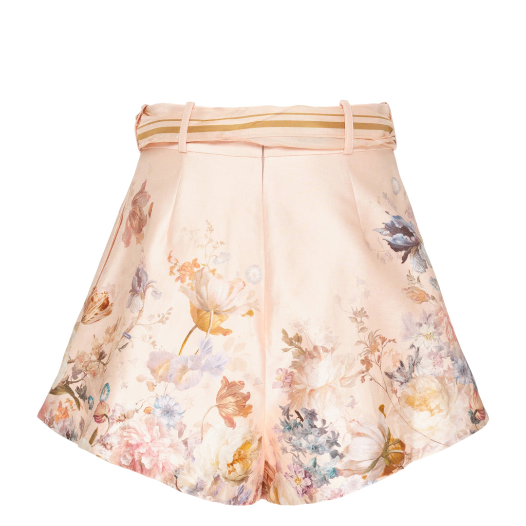 Zimmermann Valiant Tuck Shorts in blush pink with an all-over botanical floral print, featuring a full pleated silhouette, high waistband, and a striped sash bow tie at the front