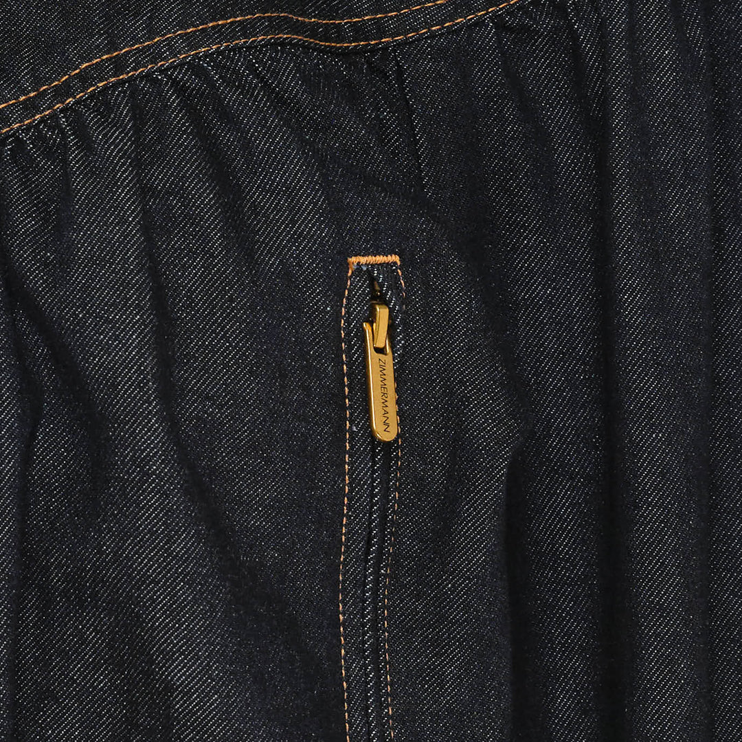 Zimmermann Denim Handkerchief Bomber Jacket in dark indigo with orange contrast topstitching, gathered ruched panels, gold-tone zip pockets, stand collar, and elasticated ribbed hem and cuffs