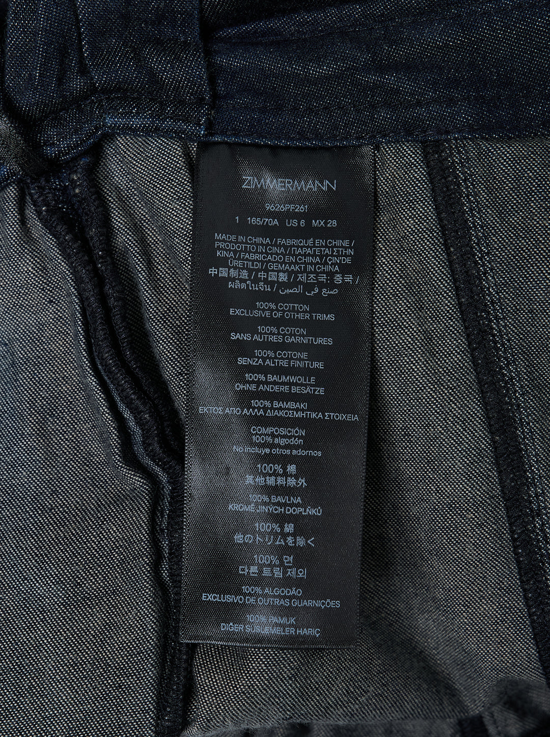 Zimmermann Draped Denim Flare Jeans in dark indigo, featuring a wide-leg silhouette with a wrap-style skirt overlay and self-tie gather detail at the hip - view 4