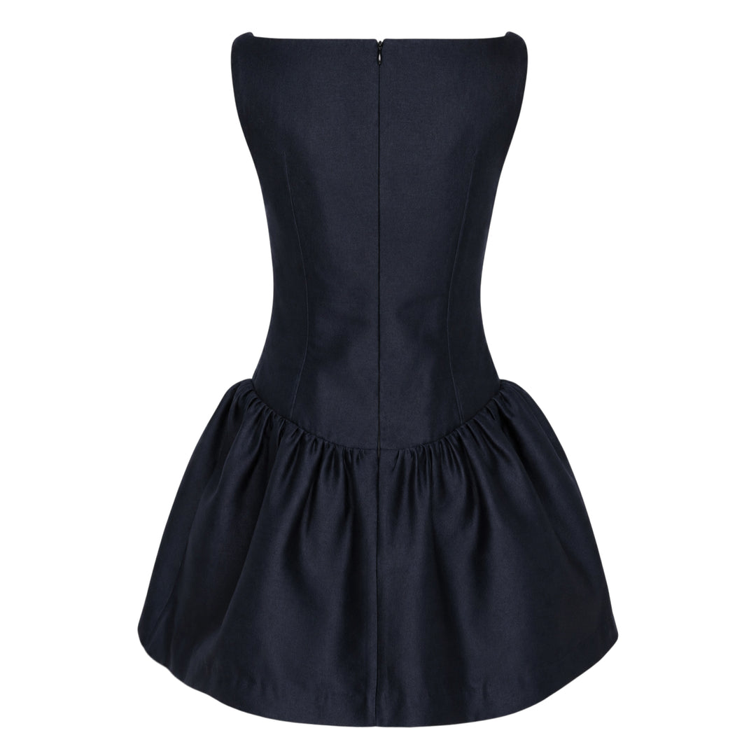 SHUSHU/TONG navy drop-waist mini dress with open keyhole back, ruffled trim detailing, velvet bow accent, and full gathered skirt — rear view