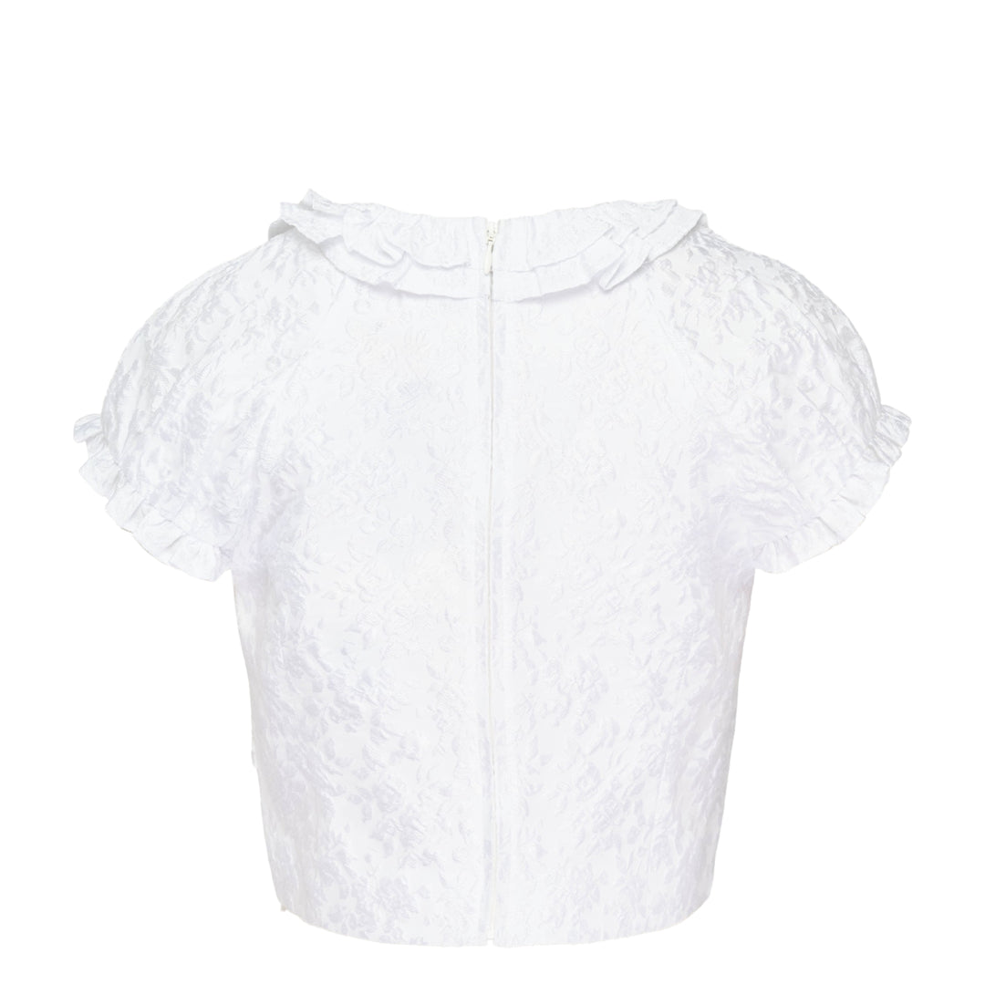 SHUSHU/TONG white jacquard ruffled bow crop top with puff sleeves, ruffle collar and hem trim, and structured satin bow at the centre front neckline, shown from the back