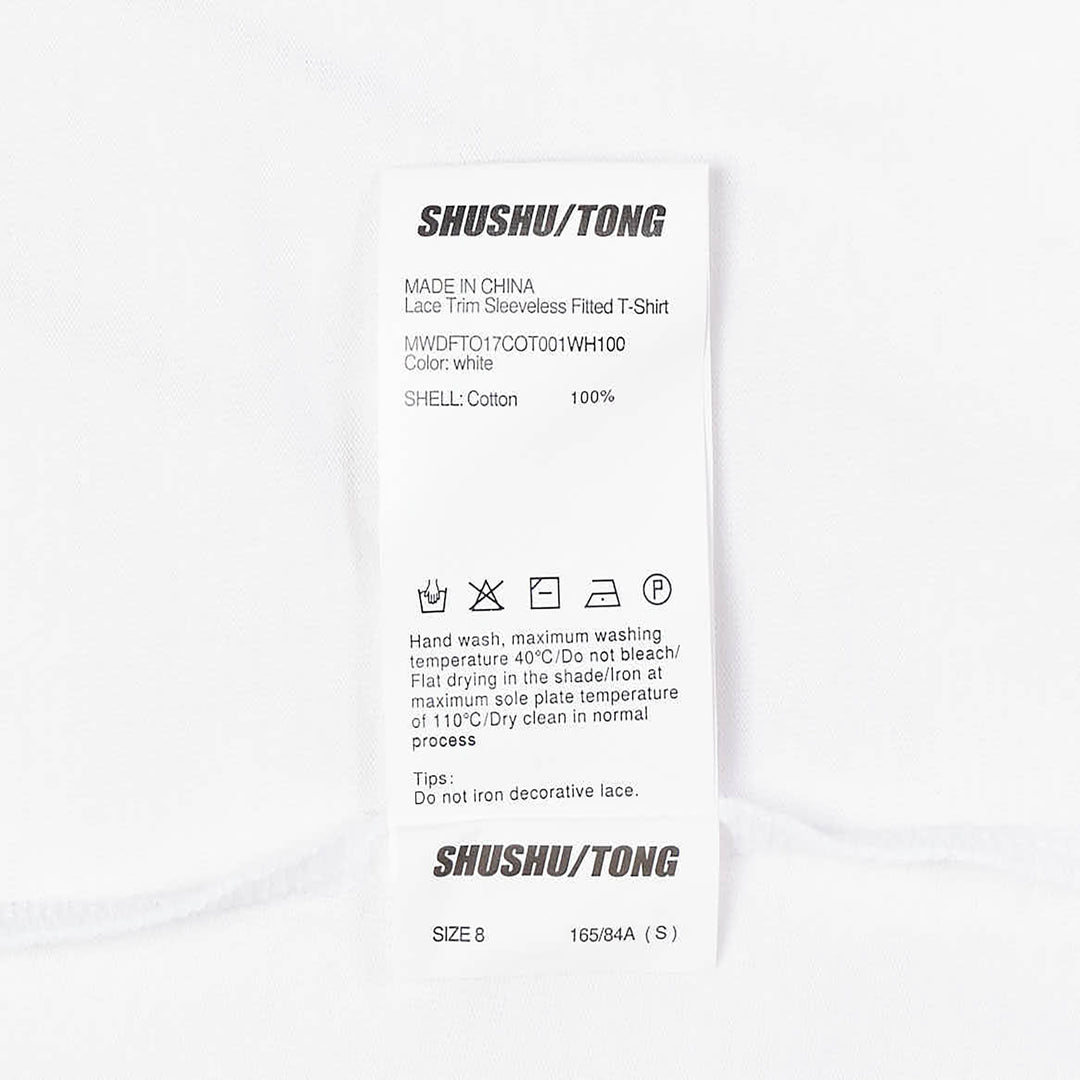 SHUSHU/TONG white sleeveless fitted top with twin vertical ruffle trim detailing running from the neckline toward the waist, shown from the front against a white background
