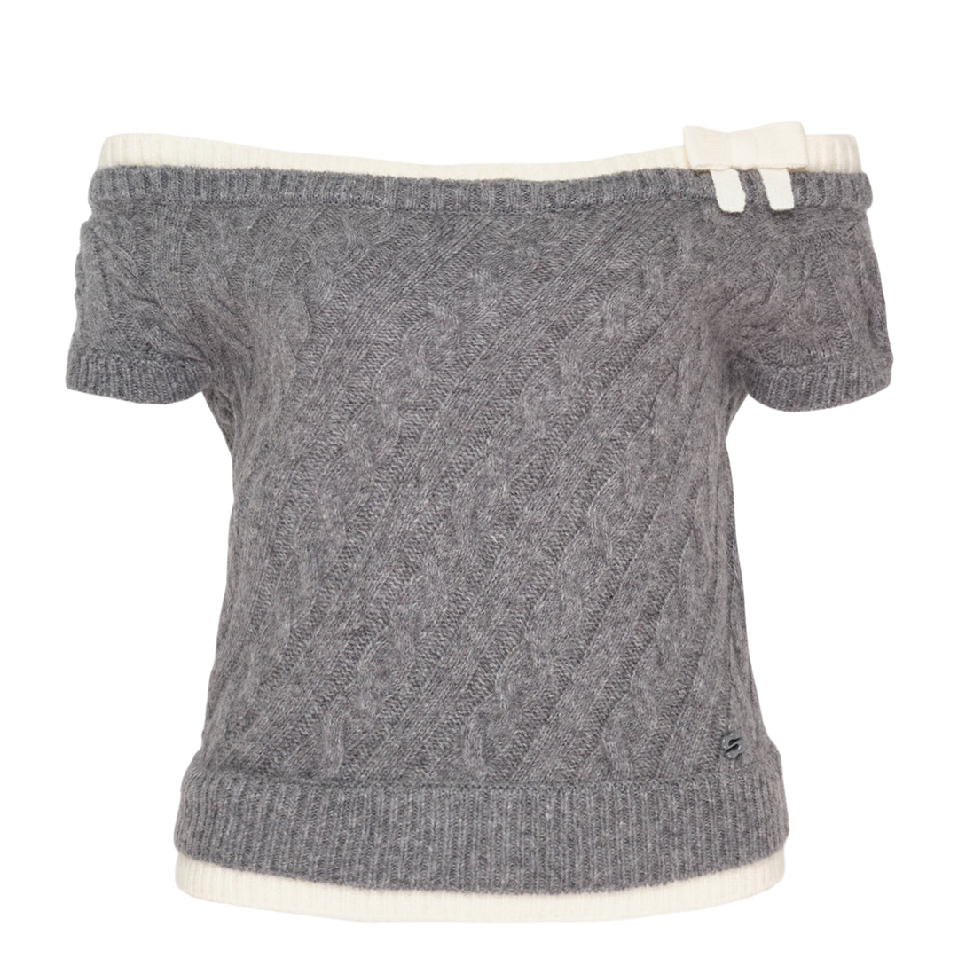 SHUSHU/TONG baby blue cable-knit off-shoulder crop top with cream contrast ribbed trim, bow accent at the neckline, and short sleeves, displayed flat on a white background